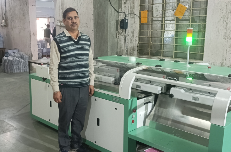 Bookbinding production facility at Adhunik Book Binders showcasing Bindwel WB@2500 perfect binder and Trident E20 machine producing large volumes of softcover educational books with high-speed, consistent finishing quality