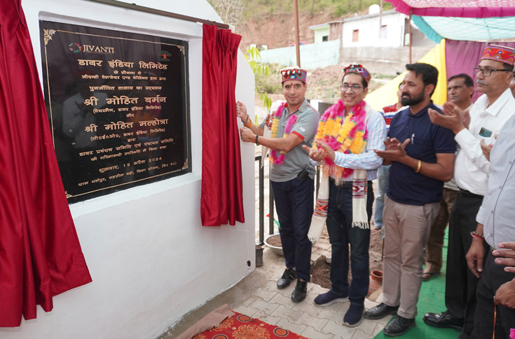 Representatives from Dabur India inaugurating a restored village pond project focused on water conservation and sustainable community development in Dharampur