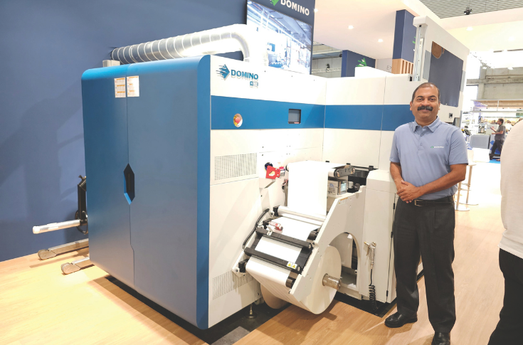 Visitors at a digital printing exhibition stand discussing label printing technology, reflecting growing interest in digital presses, automation, and cost-efficient production solutions