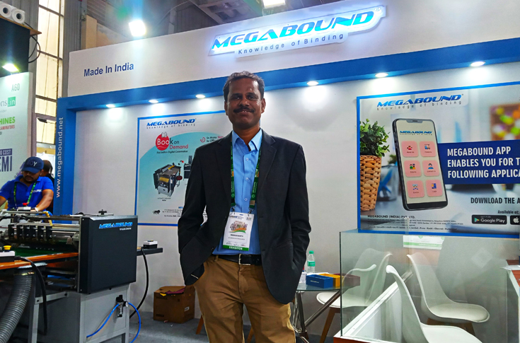 Megabound booth at Bharat Print Expo 2025 in Bengaluru displaying rigid box-making and packaging machinery such as case makers, folding and gluing systems, and automated finishing equipment, attracting trade visitors and business deals