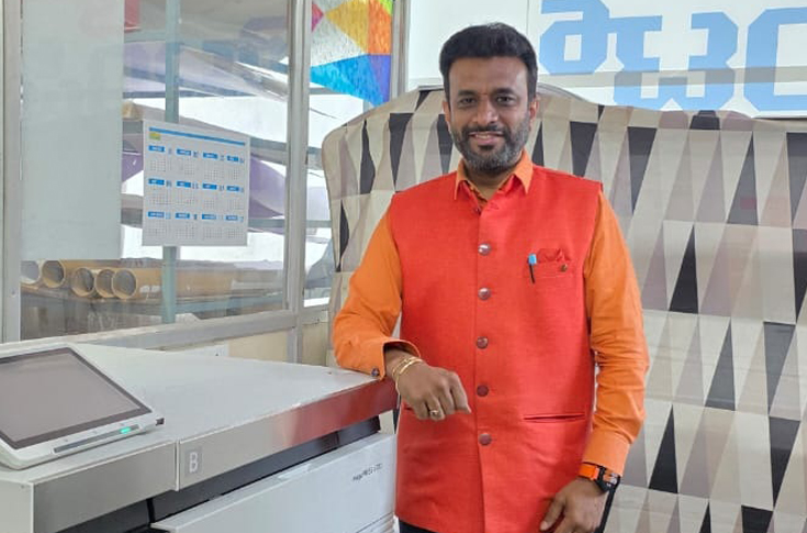 Digital printing facility operating a Canon iPR V700 production press producing brochures, invitation cards, and specialty print jobs on varied paper stocks