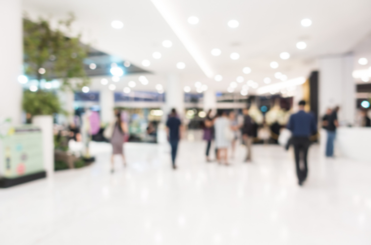 Industry expo showcasing printing machinery, technology displays, and professionals networking with manufacturers and service providers in a business exhibition environment