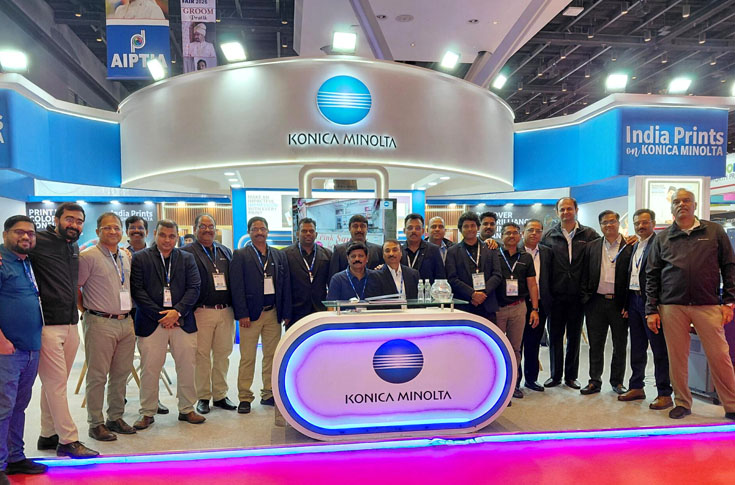 Konica Minolta exhibition booth displaying AccurioPress C84hc and C7100 presses with live demonstrations of high chroma colour printing, photo album production, and advanced print finishing solutions