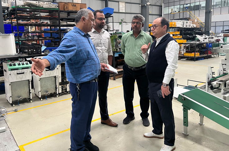 Representatives from Repro India and Bindwel Technologies discussing the new Bindline bookbinding system order at PrintPack 2025