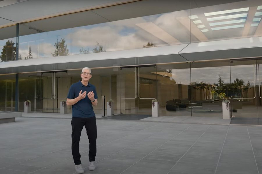 Tech keynote presentation with a speaker introducing a product launch, highlighting design storytelling and audience engagement rather than technical specifications