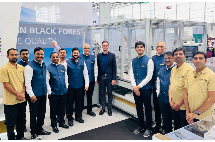 Pratham Technologies automated outsert packaging system featuring iRPF 53 folding machine and STP 1200 robotic tray packing system with sensors for defect detection and high-efficiency leaflet packaging