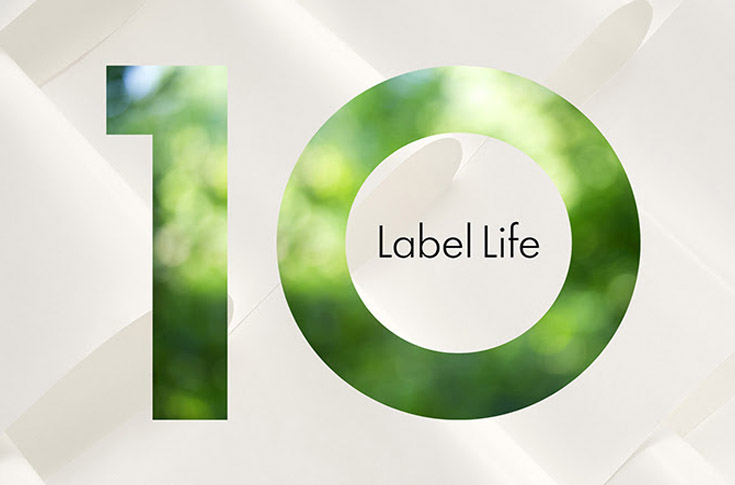 UPM Raflatac Label Life sustainability platform displaying life cycle assessment data and product passport prototypes for label materials, highlighting greenhouse gas emissions, energy demand, and water consumption metrics