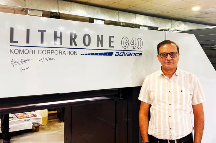 Large commercial printing facility equipped with multiple Komori offset presses producing books and packaging materials, showcasing advanced pre-press, press, and post-press operations