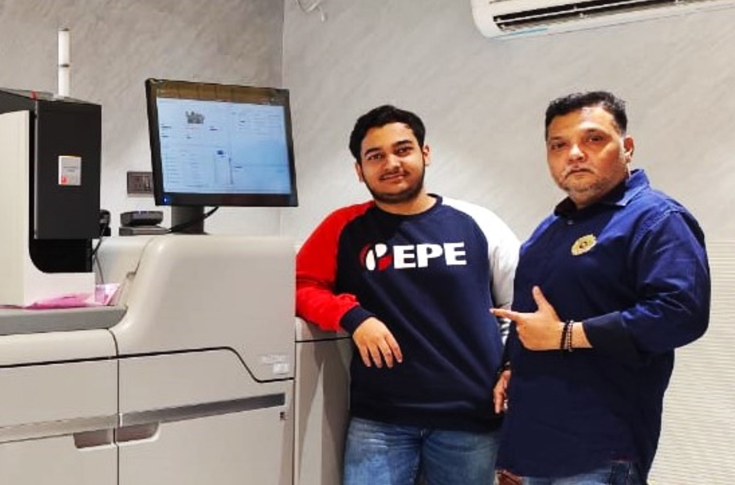 Saifi Screens printing facility operating Ricoh Pro C7500 digital colour production press with fifth-colour capabilities, alongside offset presses and finishing systems for brochures, flyers, catalogues, and commercial print products