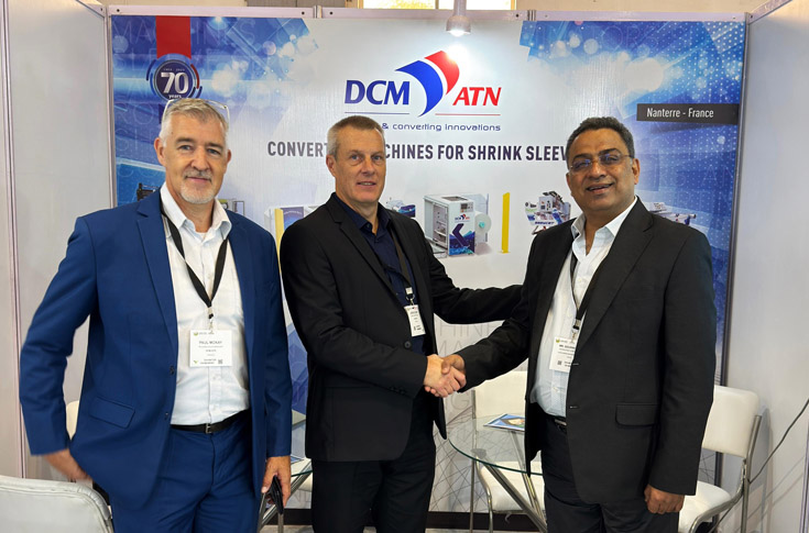 DCM ATN and Flexo Image Graphics representatives discussing printing, lamination, slitting, and shrink sleeve converting machines, emphasizing precision and efficiency in packaging production equipment