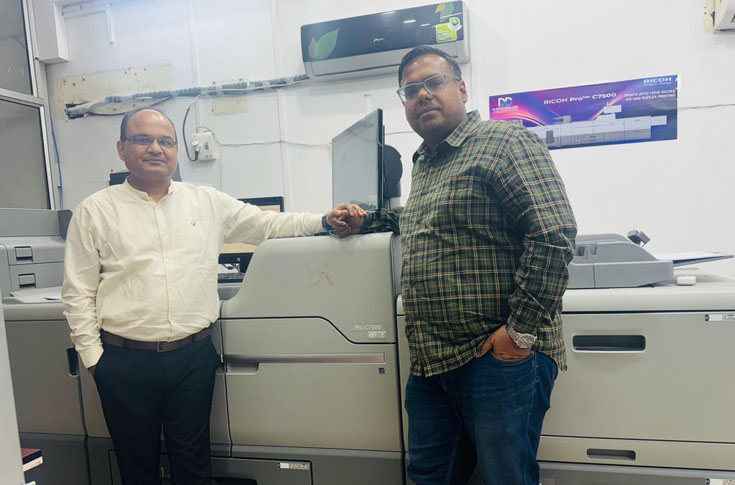DD Enterprises operating Ricoh Pro C7500 digital press alongside Canon large-format printer and post-press finishing equipment for brochures, banners, stickers, and commercial print production