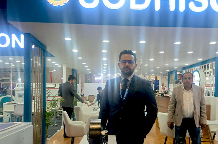 Sanchit Sodhi of Sodhisons Mechanical Works showcasing a gold foiling machine at PrintPack 2025 alongside discussions on packaging machinery demand, automation, and recent customer deals