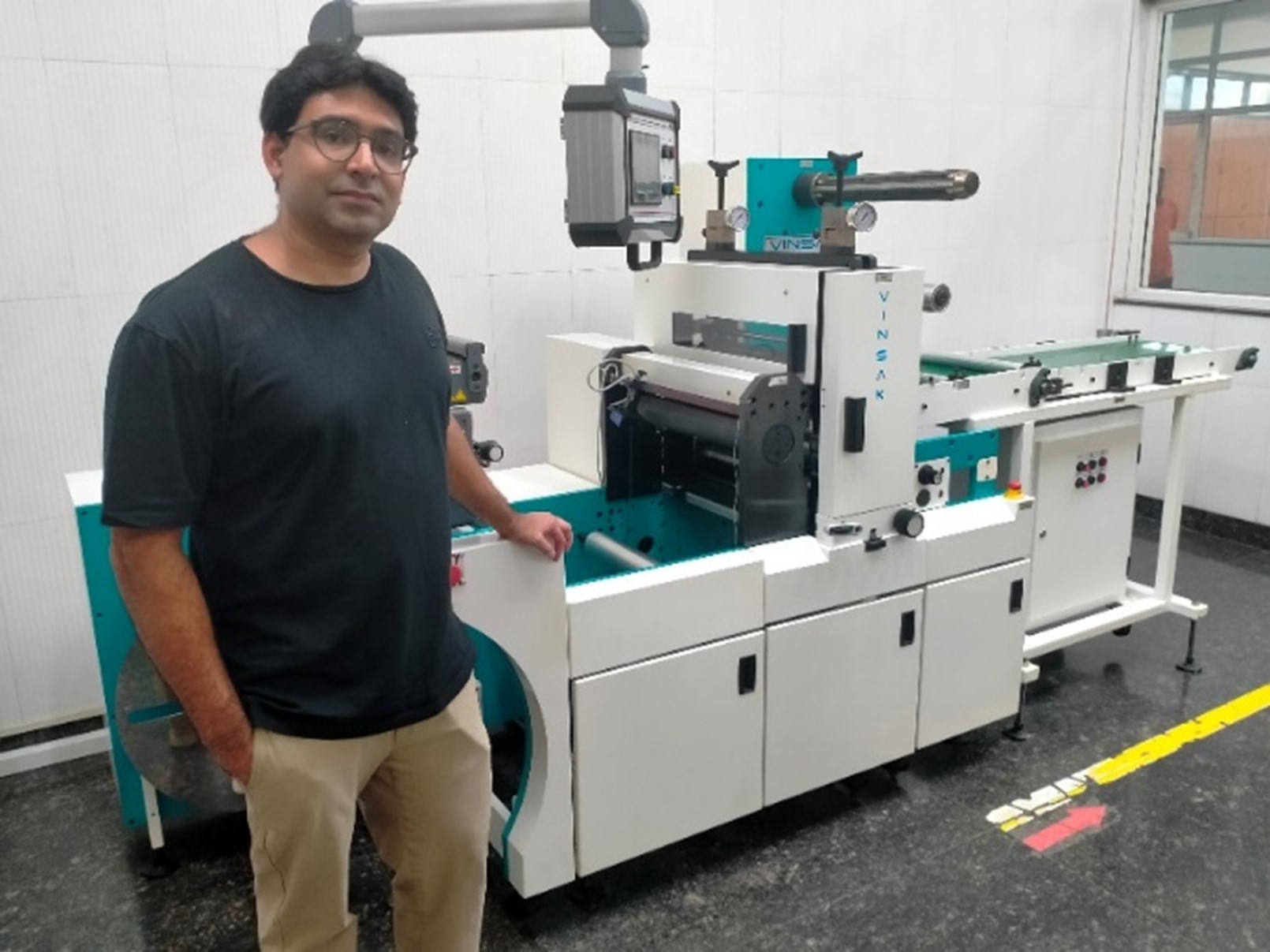 Advanced label converting machine with servo-driven rotary die-cutting, modular slitting and conveyor system used for precision self-adhesive label production in a high-compliance printing facility