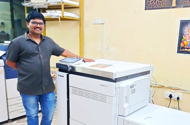 Canon imagePRESS V800 digital colour production press in a commercial print shop producing brochures, business cards, labels, and promotional signage materials for diverse customer applications