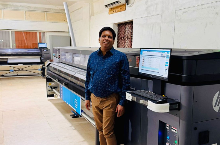 Balaji Corporation print production facility using HP Latex 1500 printer for high-quality sign and display graphics on materials such as vinyl, canvas, wallpaper, and backlit fabrics with durable, crack-free output