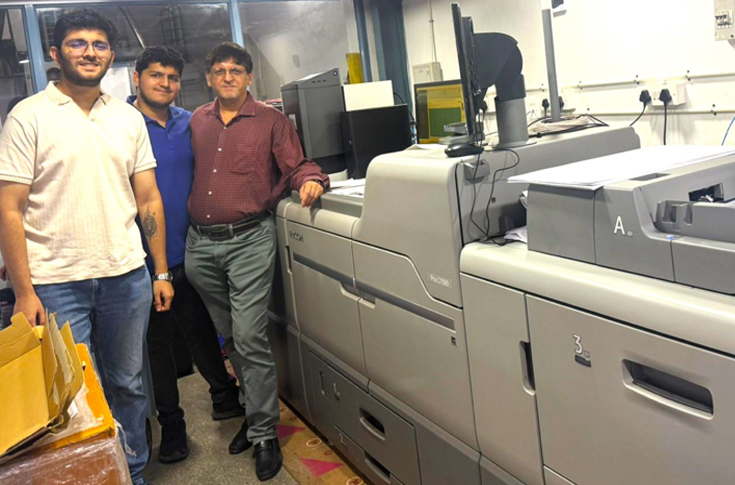 Chennai-based JB Khanna Prints production facility featuring a Ricoh Pro C7500 digital colour press used for high-resolution religious posters and graphic printing alongside skilled operators