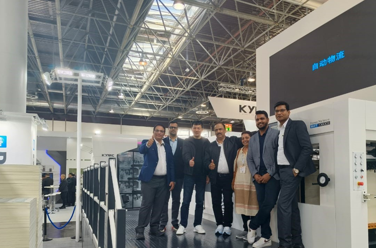 BHT-1060 CE automatic die-cutting machine operating at high speed in a packaging facility, used by Dolly Printing & Packaging to support corrugation and pharmaceutical packaging production