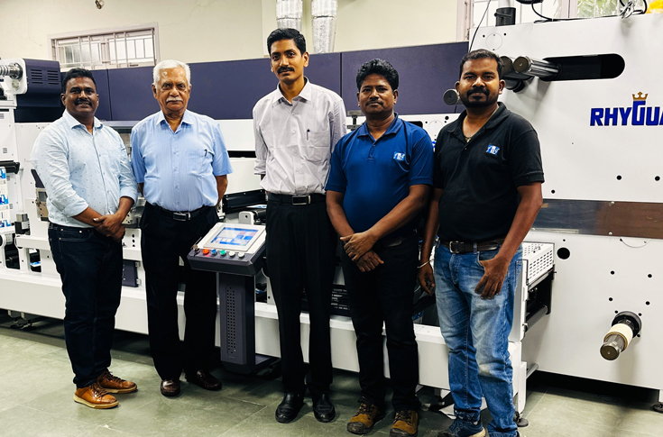 Alpha Industry, established in 1978, is a commercial printing and packaging company operating with its sister concern PrintWrap, serving liquor and FMCG clients with high-quality label production. The company uses advanced equipment supplied by Flexo Image Graphics, including Mark Andy presses, Rotoflex VSI systems, and the Rhyguan Plus Series finishing system. The latest Rhyguan installation enables multi-embellishment processes such as foiling, varnishing, lamination, and die-cutting, enhancing label quality and value