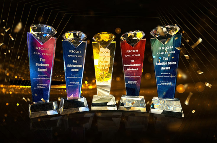 Monotech Systems team receiving awards at Ricoh Asia Pacific Partner Meet, recognised for Top Achievement, Partner of the Year, and excellence in production printer and solution sales