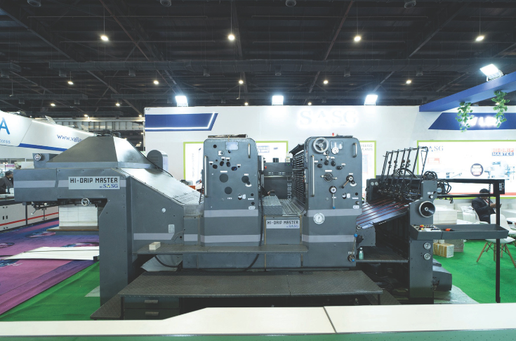 High Drip Master UV coating machine by SASG UV Solutions showcased at PrintPack 2025, featuring advanced spot UV, drip-off, and multi-effect coating capabilities for commercial and packaging printing