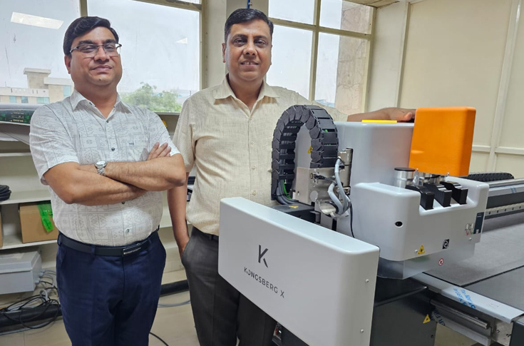 Adway Print Concept production facility featuring Kongsberg sample maker used for die-less sample development and KDX HZ lamination machine for high-volume laminated sheet production, supporting eco-friendly metPET applications and automated 24-hour operations producing around 75,000 sheets daily