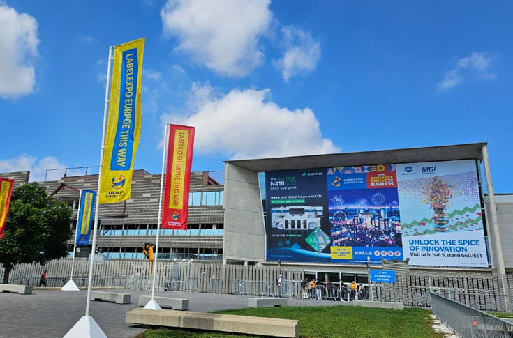 Busy Labelexpo exhibition floor showcasing advanced label, flexible packaging, and folding carton technologies with diverse machinery and industry visitors