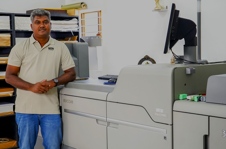Commercial print facility in Coimbatore operating a Ricoh Pro C7500 digital production press producing high-quality colourful prints with advanced toner effects such as white, gold, silver, and neon applications