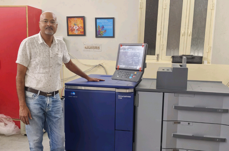 Digital printing setup at Print Media Publication facility featuring Konica Minolta AccurioPress C7090 production press, showcasing modern digital print operations, production workflow, and small business transition from publishing to full-scale printing services