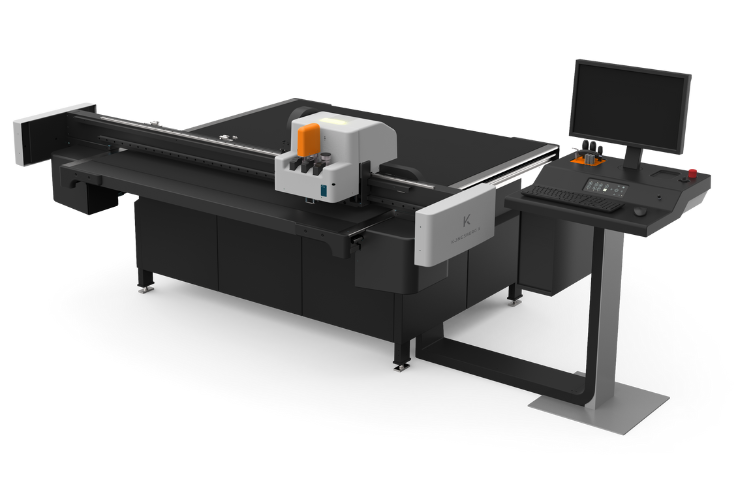 Kongsberg PCS demonstrating the Kongsberg X20 digital cutting table for packaging applications, showing precision cutting of corrugated materials and flexible short-run production capabilities at Pamex exhibition
