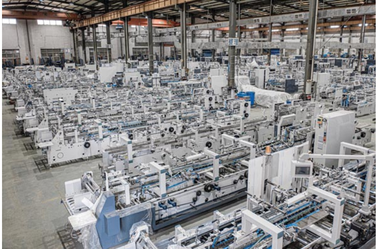 DGM Automation showcasing SmartFlute 1450 servo-driven flute laminator, Technocut 1050S automatic flatbed die-cutter, and TechnoFold 1100SL laminator at PrintPack 2025, featuring high-speed precision finishing and corrugation solutions