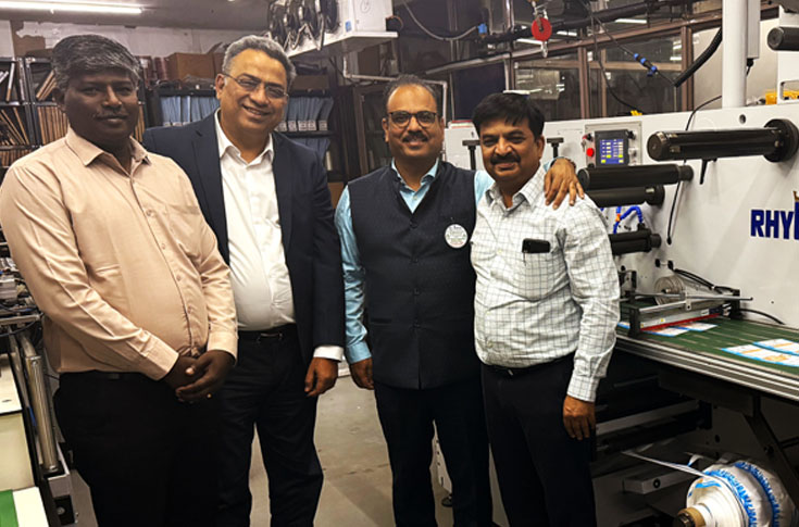 Astron Packaging facility featuring Rhyguan TOP-330 label die-cutting machine alongside inspection systems and flexo presses for high-precision label production