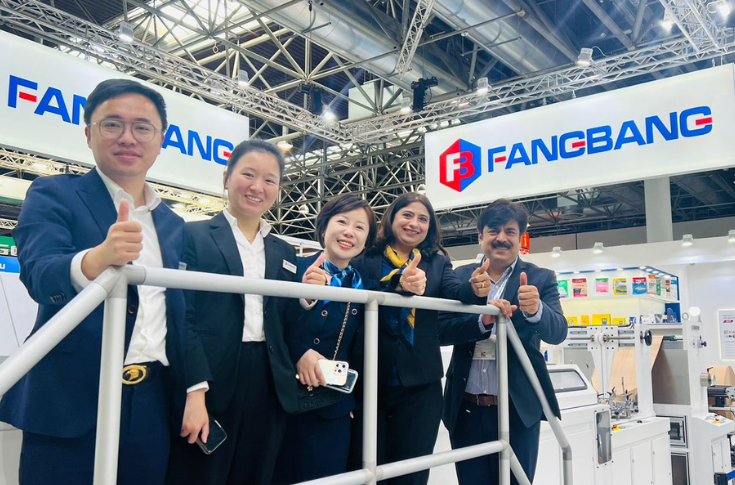 Fangbang paper bag and packaging machines displayed at Drupa exhibition, featuring fully servo automatic roll-fed square-bottom bag machines, SOS V-bottom systems, and flexo printing units for high-speed production