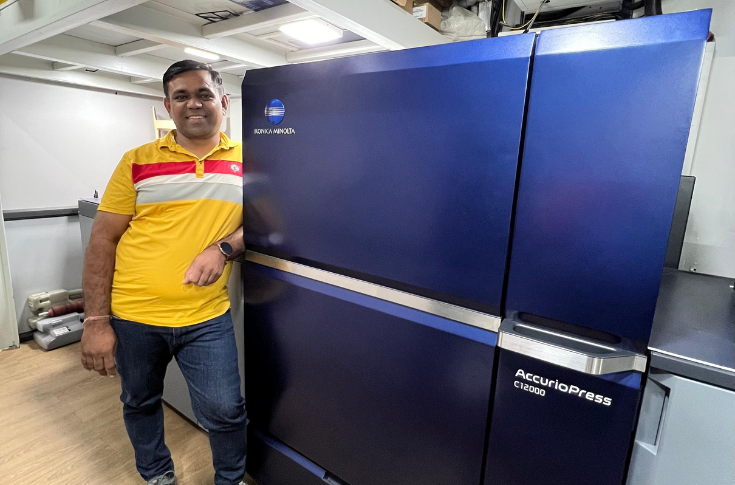 Erica Digital team operating Konica Minolta AccurioPress C12000 for high-volume brochures, visiting cards, stickers, and customised digital printing services