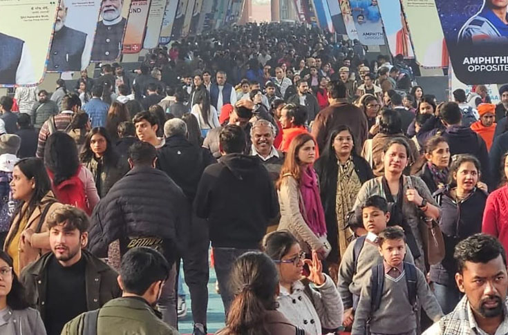 Crowded book fair hall with families, students, and senior citizens browsing discounted books, publishers’ stalls, and cultural programs such as poetry recitations and children’s activities at Bal Mandap on the final day of the event